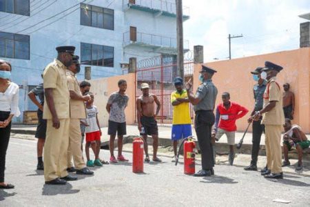 Members of the Guyana Fire Service demonstrating the use of extinguishers yesterday in Tiger Bay. (Guyana Fire Service photo)