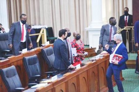Finance Minister Colm Imbert, right, pumps his fist yesterday as he chats with Attorney General Faris Al-Rawi, from left, Prime Minister Dr Keith Rowley and Planning Minister Camille Robinson-Regis following his presentation of the 2021/22 budget in Parliament at the Red House. —Photo: ISHMAEL SALANDY