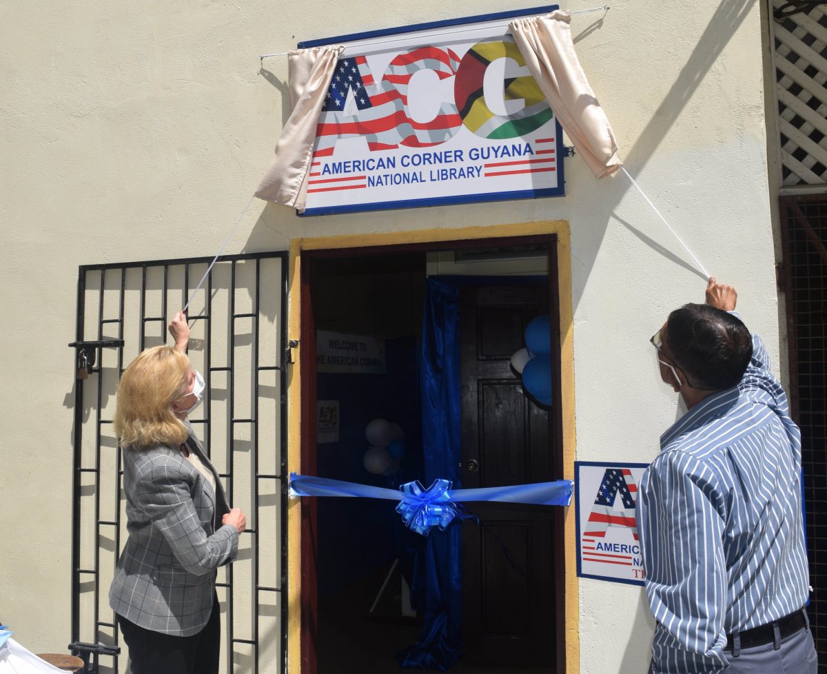 US Ambassador Sarah-Ann Lynch (left) and Petamber Persaud unveiled the plaque to open the American Corner Guyana.  (US Embassy photo)
