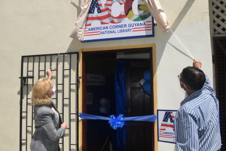US Ambassador Sarah-Ann Lynch (left) and Petamber Persaud unveiled the plaque to open the American Corner Guyana.  (US Embassy photo)
