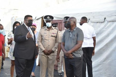 President Irfaan Ali (left) this morning visiting the temporary facilities set up for the police. (Office of the President photo)