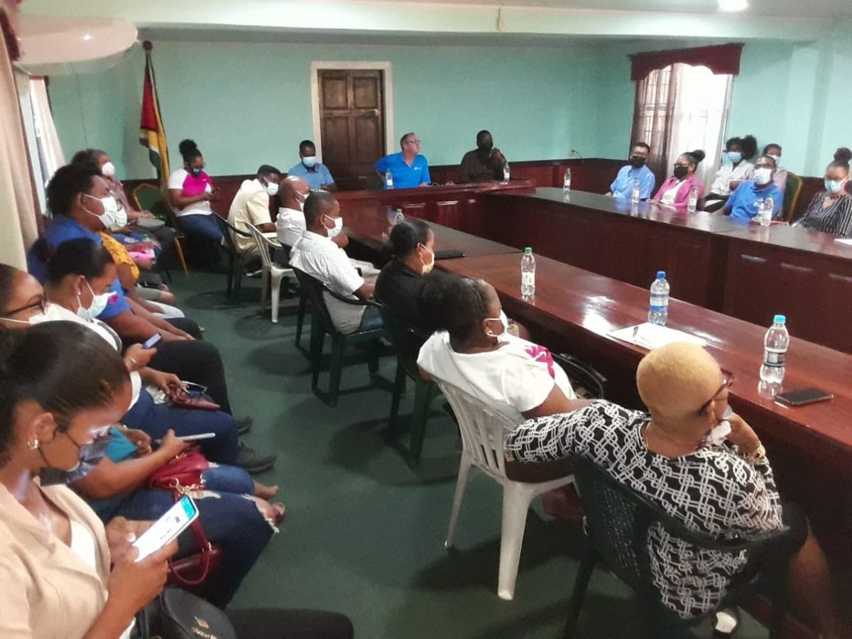 Residents of Bartica at the meeting with an executive team from GTT lead by CEO Damien Blackburn (seated at the head of the table)