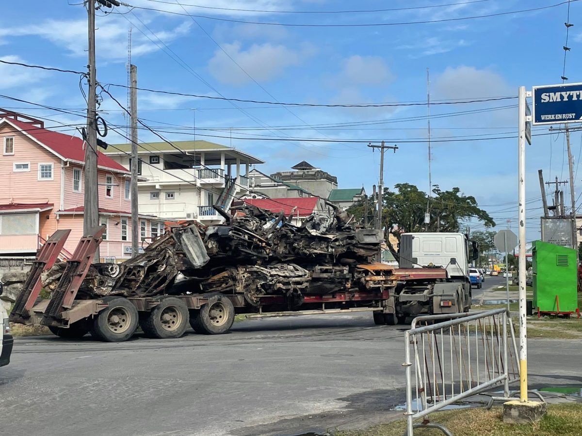 A trailer removing several burnt vehicles from the Brickdam Police Station yesterday.
