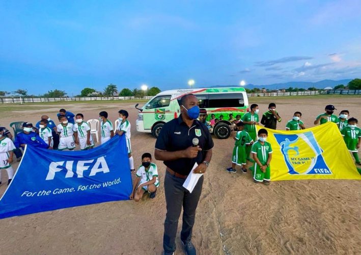 The Guyana Football Federation Saturday donated a 19-seater HiAce bus (in the background) to the Rupununi Football Association.