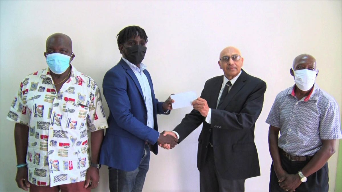 GRFU’s Senior Vice-President Joshua Griffith receives the cheque from GOA President K.A Juman-Yassin in the presence of Manager George David (left) and Secretary Terrence Grant.