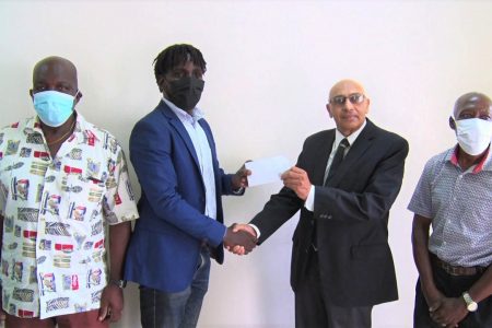 GRFU’s Senior Vice-President Joshua Griffith receives the cheque from GOA President K.A Juman-Yassin in the presence of Manager George David (left) and Secretary Terrence Grant.