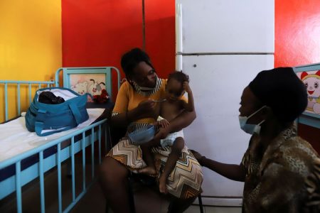 Mirlande Cherie, accompanied by her mother, feeds her infant son Pierre while waiting for medical attention for him at La Paix University Hospital, where only the paediatric ward was operating amid a shortage of fuel to run generators, in Port-au-Prince, Haiti October 27, 2021. Picture taken October 27, 2021. REUTERS/Ralph Tedy Erol