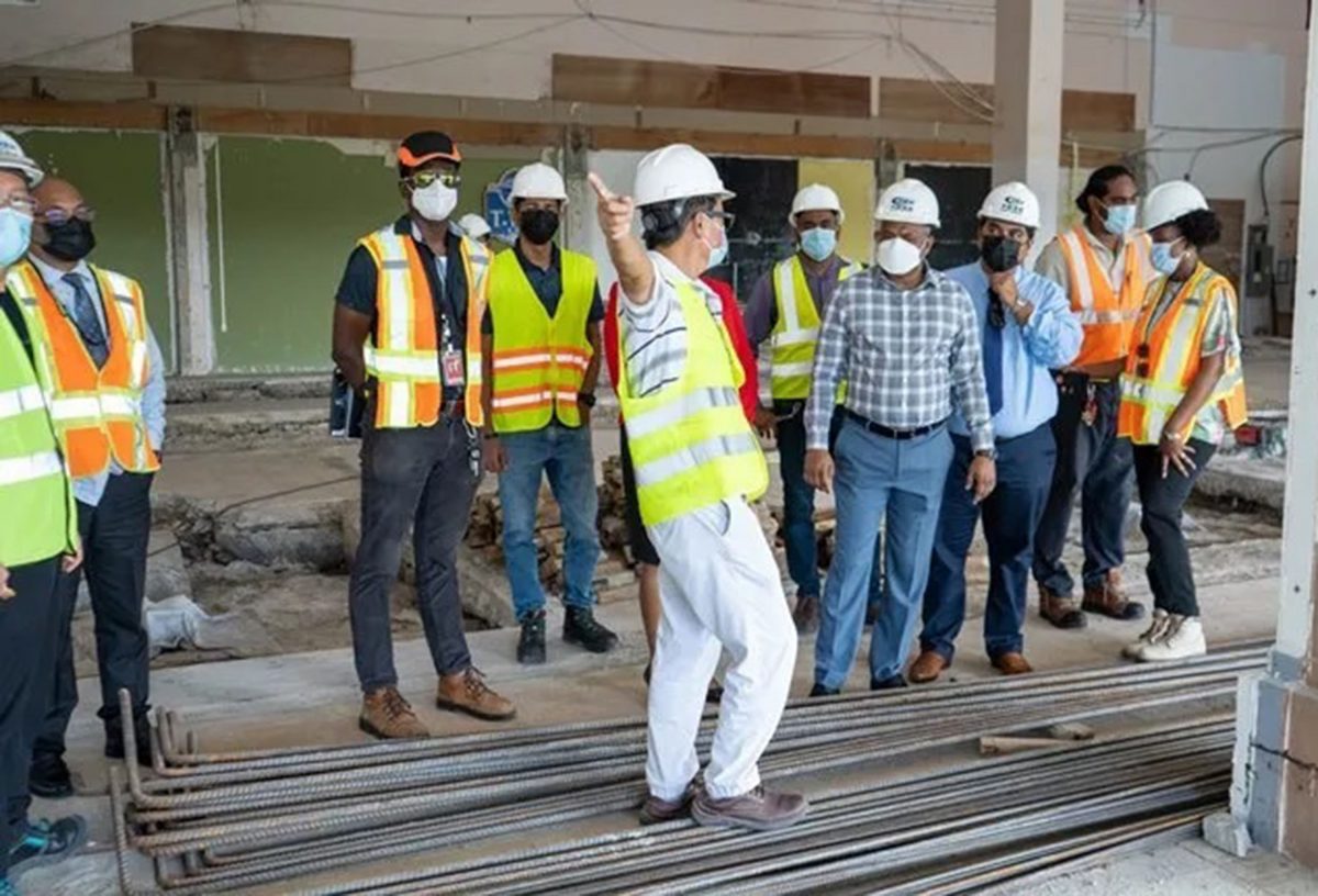 Minister in the Ministry of Public Works Deodat Indar (fourth from right) during his inspection of the airport project (DPI photo)
