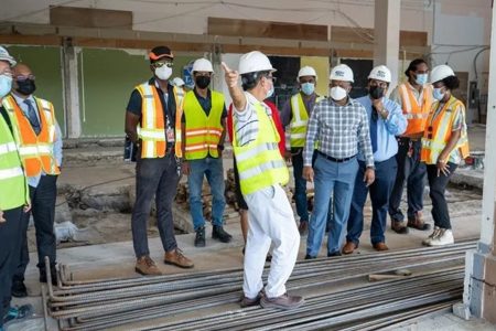 Minister in the Ministry of Public Works Deodat Indar (fourth from right) during his inspection of the airport project (DPI photo)
