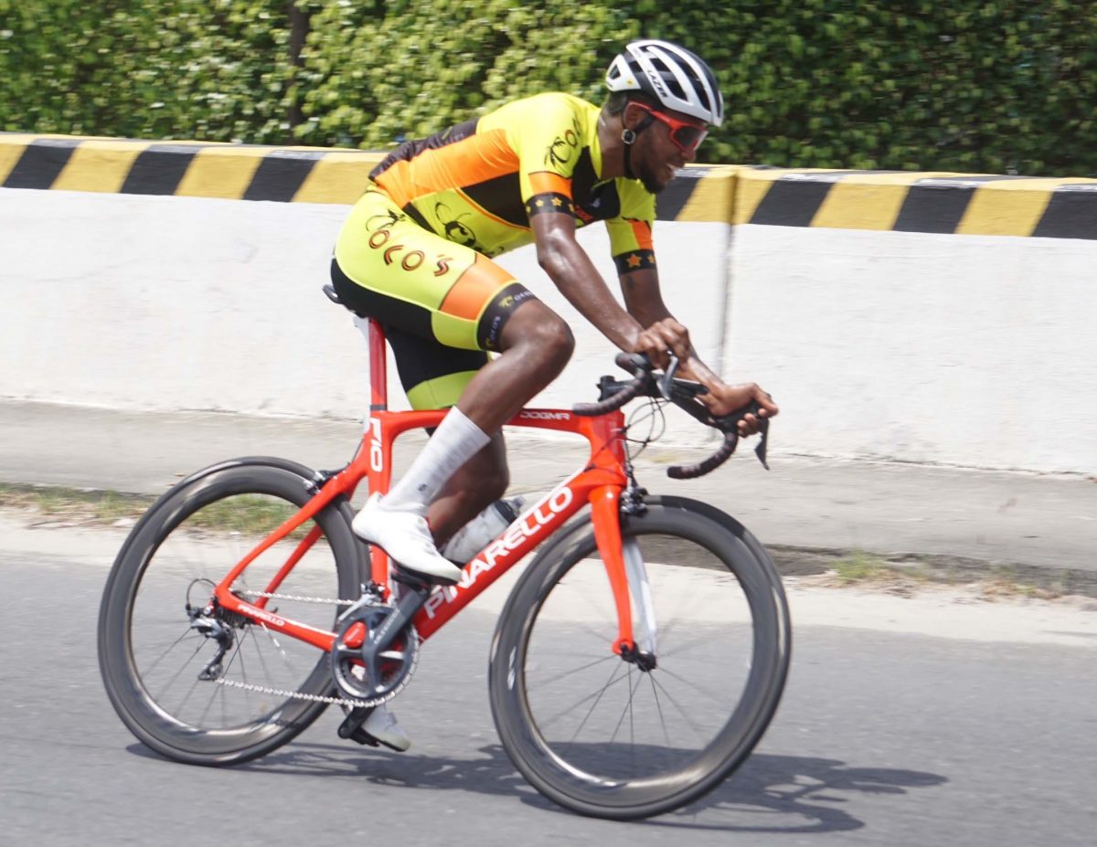 Riding in a crisp Team Coco’s neon green racing kit, Jamual John made hay in the brilliant sunshine, stopping the clock in 3h:17m.21s to win the 10th edition of the Kadir Memorial Ounce of Gold race. (Emmerson Campbell photo)
