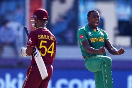 Lendl Simmons trudges off following his pedestrian 16 from 35 deliveries against South Africa on Tuesday, as fast bowler Kagiso Rabada celebrates.
