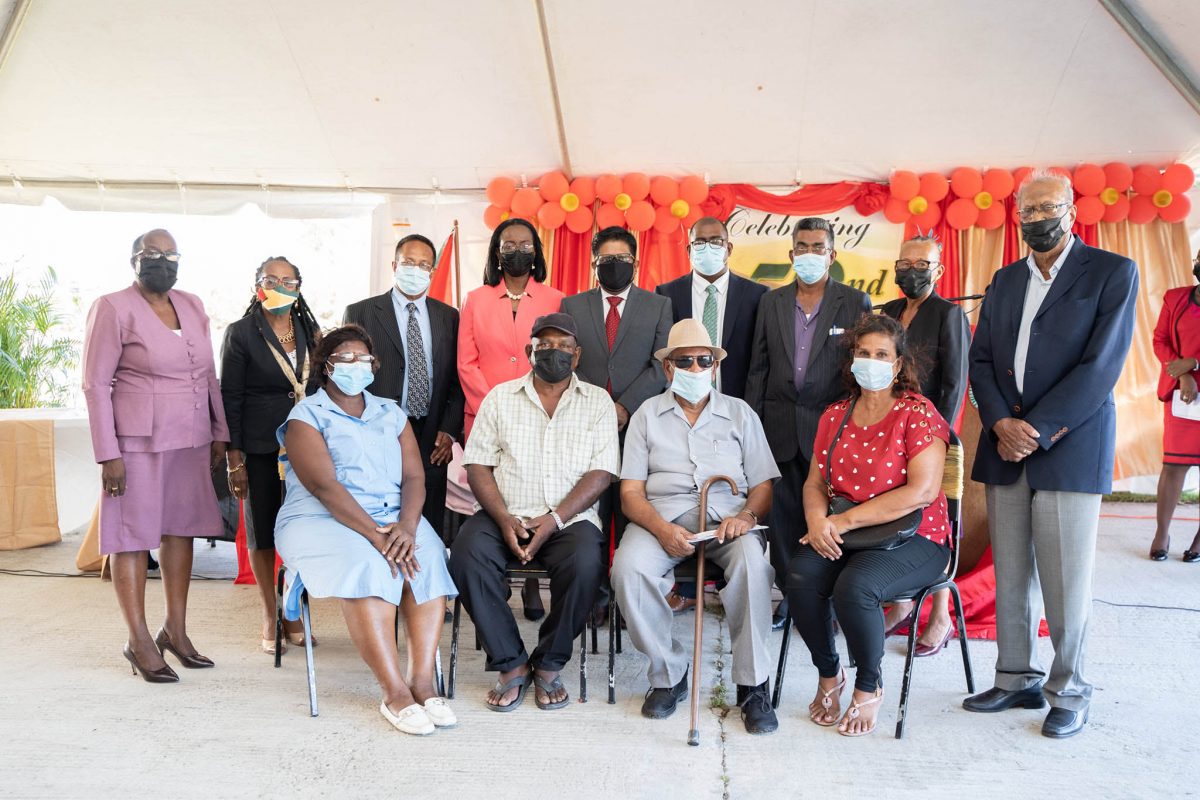 86-year-old Shamean Matthews (seated 3rd from left) among other pensioners who received their pension books along with Dr Ashni Singh (standing 5th from left), the Board of Directors and NIS General Manager Holly Greaves (standing 4th from left). 