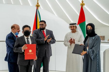 Reem Ebrahim Al-Hashimy, Minister of State for International Cooperation (right)  and Senior Minister with responsibility for Finance in the Office of the President, Dr Ashni Singh (second from left) after the signing.
