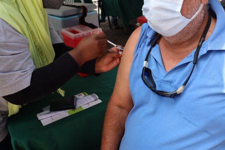 NWRHA Registered Nurse Taquiyyah Ali administers the J&J COVID-19 vaccine to San Juan resident Neshan Mohammed, during an NWRHA vaccination community outreach, at the San Juan/ Laventille Regional Corporation, MTS Plaza, Aranguez.