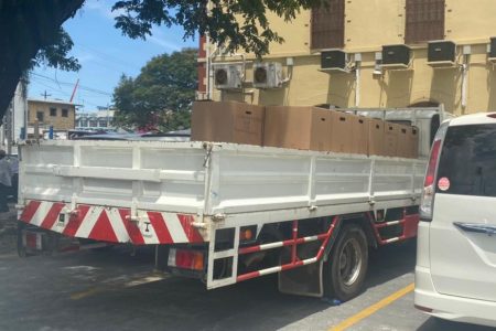 A truck loaded with the certified copies of State-ments of Polls (SOPs) and Statements of Recount (SORs) from the March 2020 general and regional elections parked outside the Georgetown Magis-trate’s Court compound. The boxes were guarded by police officers. 