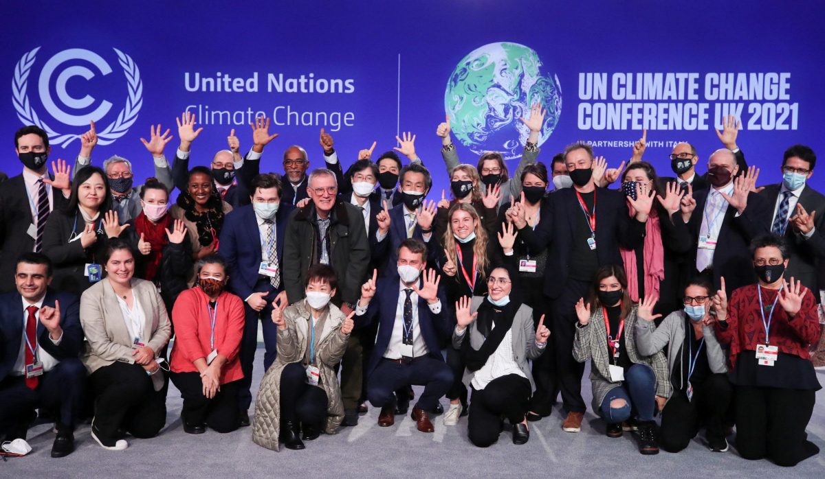 Delegates pose for a picture during the UN Climate Change Conference (COP26) in Glasgow, Scotland, Britain November 13, 2021. (REUTERS)