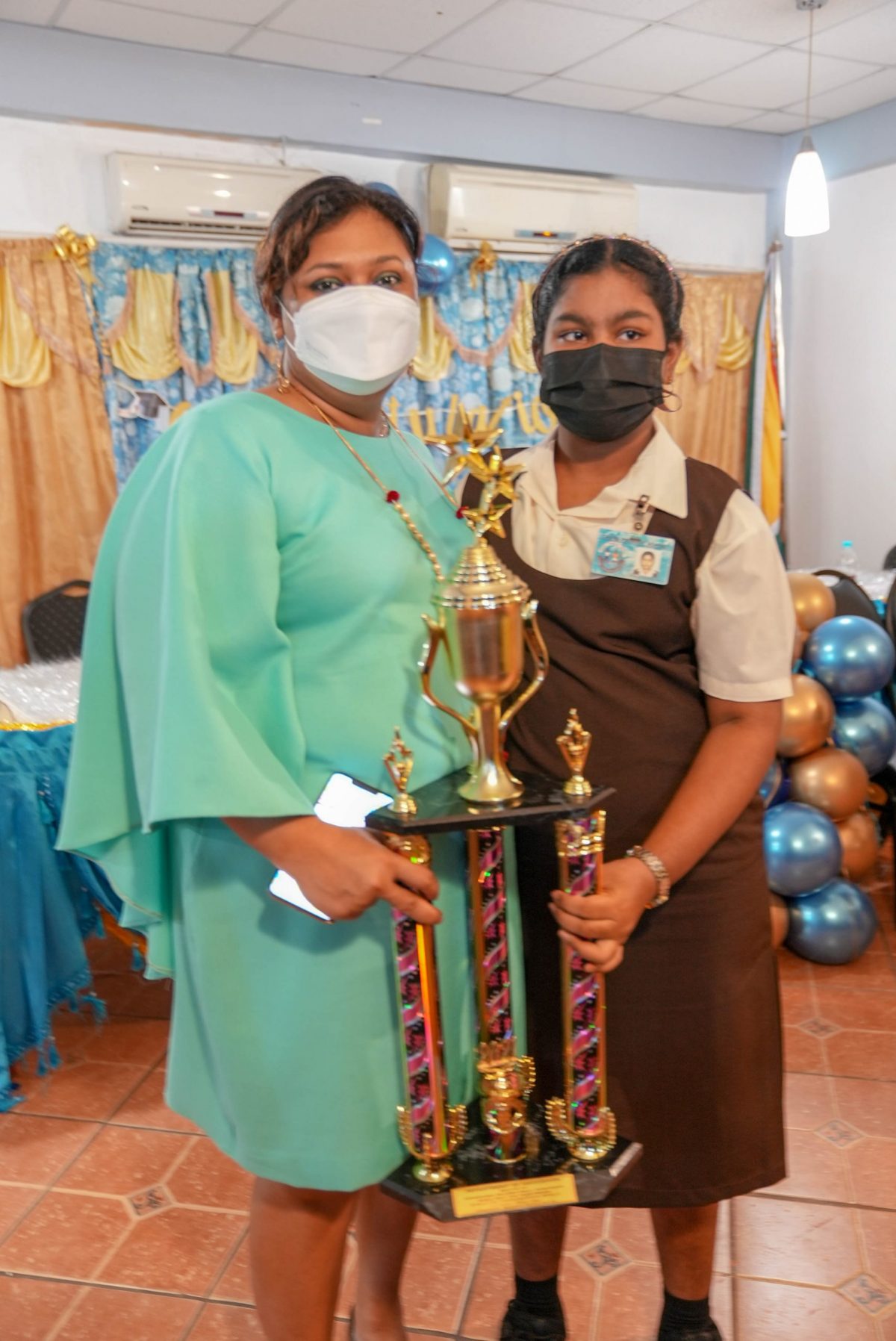 Emily Vaamonde-Beria poses with Education Minister Priya Manickchand, who handed over one of the prizes won by the student at an award ceremony for Region Three’s top NGSA performers (Education Ministry photo) 