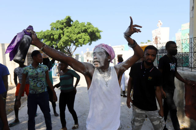  A man with powder on his face dances during Day of the Dead celebrations at a cemetery, in Port-au-Prince, Haiti November 1, 2021. (REUTERS/Ralph Tedy Erol photo) 