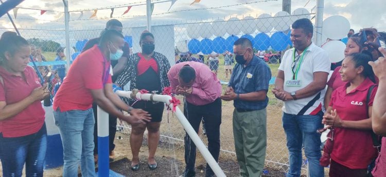  Housing and Water Minister, Collin Croal samples the water from the Kamarang well (GWI photo) 