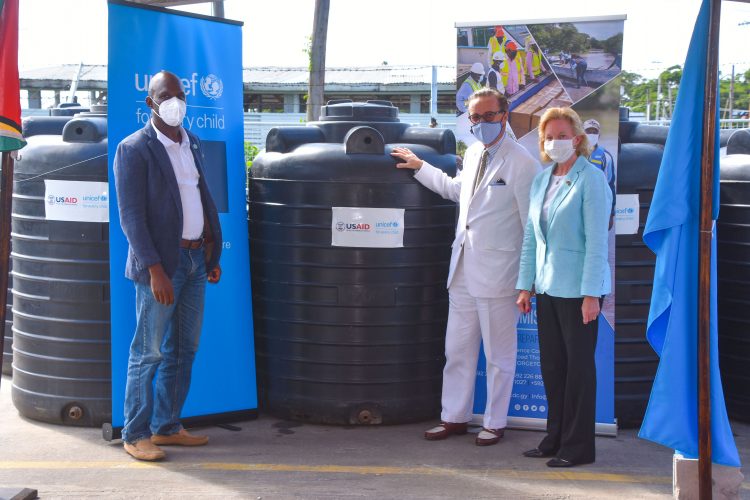 From left are CDC Director General, Lieutenant Colonel Kester Craig, UNICEF Representative Nicolas Pron and United States Ambassador to Guyana Sarah-Ann Lynch with some of the water tanks handed over to the CDC last Friday