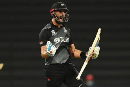 Daryl Mitchell celebrates after hitting the winning runs as New Zealand beat England in the semi-final of the T20 World Cup. 