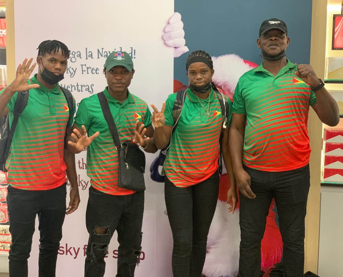 Boxers Travis Inverary, Patrick Harvey and Alesha Jackman, along with coach Terrence Poole pose for a photo prior to their departure to Colombia.