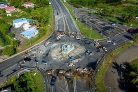 An aerial view of a barricade of burned cars and debris on a round-about blocking the traffic on highway N1 after violent demonstrations which broke out over COVID-19 protocols, in Petit-Bourg, Guadeloupe, November 23, 2021. REUTERS/Ricardo Arduengo