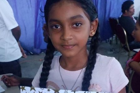 A smiling 11-year-old Anaya Lall who is currently representing Guyana at the Online World Chess Championship for people with disabilities