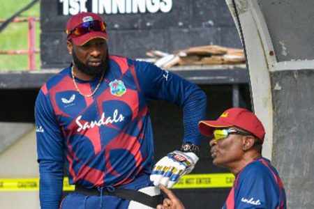 Chief selector Roger Harper (right) makes a point to West Indies white-ball skipper Kieron Pollard during the recent home series.