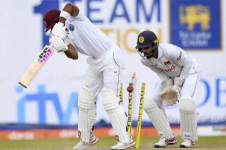 Shai Hope plays back to off-spinner Ramesh Mendis (out of picture) and is comprehensively bowled. 