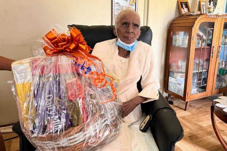 Guyana’s latest centenarian, Lilian Rosaline Chin welcomed staff from the Ministry of Human Services and Social Security to her Seaforth Street, Campbellville home on October 28th.
During the visit, Lilian and her children, grandchildren and great grandchildren chatted about her life and journey. On behalf of the Ministry, Lilian was presented with a hamper to mark the occasion.
According to a release from the Ministry, Lilian was born in 1921 in Newtown, Kitty and attended the Moravian school. When her husband passed away at 53 years, she was 51. Lilian found solace by helping children around Gordon Street, Kitty where she lived for 35 years.
Lilian is the second centenarian known to her family as her grandmother lived to be 105 years old. Her oldest child is 81.  (Ministry of Human Services and Social Security photo)