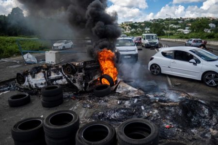 Protesters have set up burning barricades in Fort-De-France, Martinique, as anger over coronavirus restrictions grows [Ricardo Arduengo/Reuters]