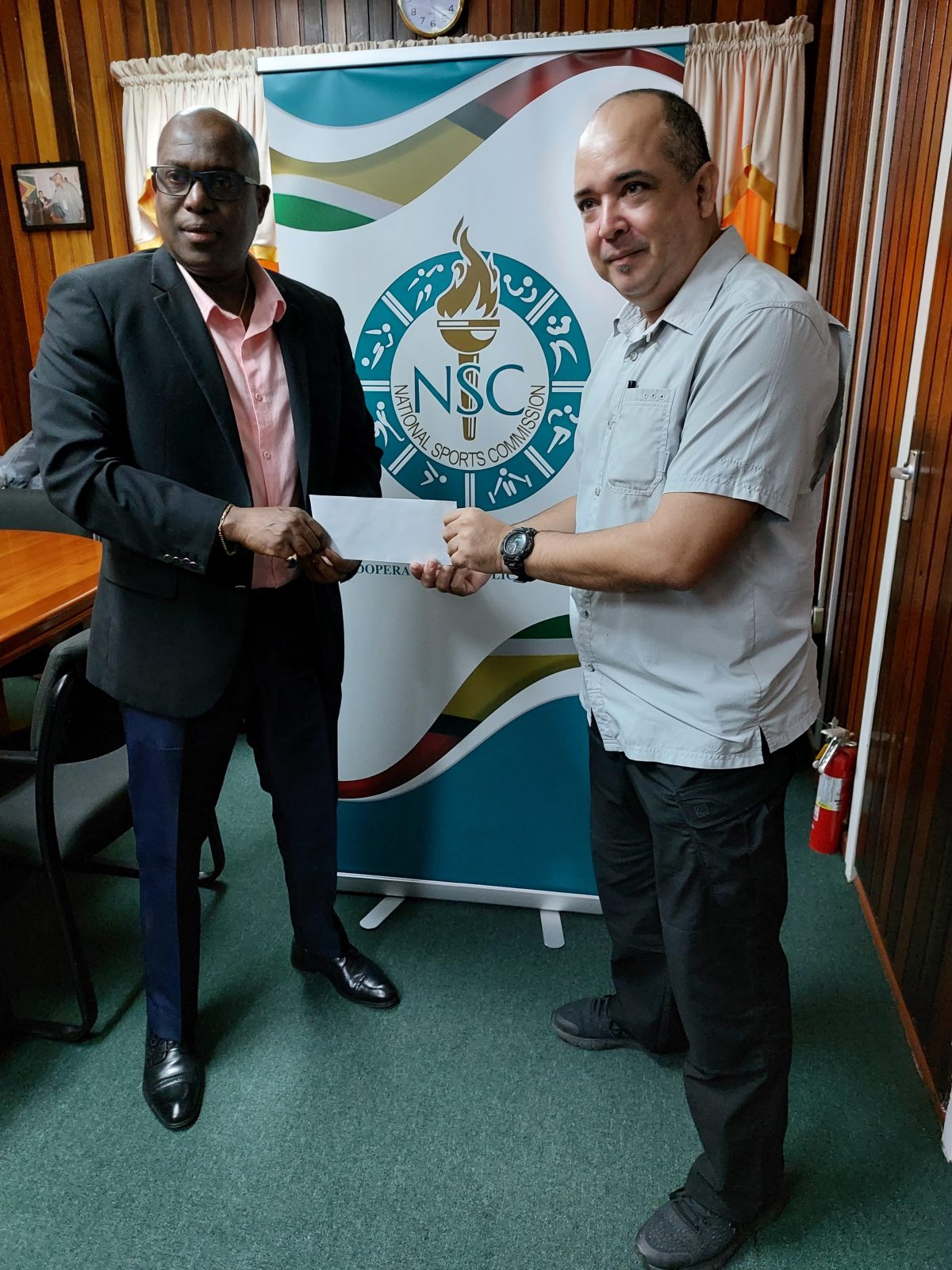 Director of Sport Steve Ninvalle (left), presenting on the sponsorship cheque on behalf of the NSC to GABF President Michael Singh.
