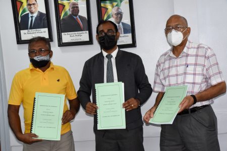 Chief Labour Officer Dhaneshwar Deonarine (centre), Human Resources Director  Andrew Carto (right) and General Secretary of the General Workers Union Pancham Singh  display the MOA following the signing. (Banks DIH photo)