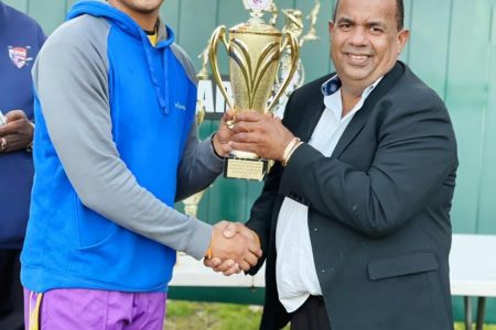 Akshaya Persaud (left) receives his accolade from businessman, Hafeez Ali.
