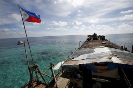 FILE PHOTO: A Philippine flag flutters from BRP Sierra Madre, a dilapidated Philippine Navy ship that has been aground since 1999 and became a Philippine military detachment on the disputed Second Thomas Shoal