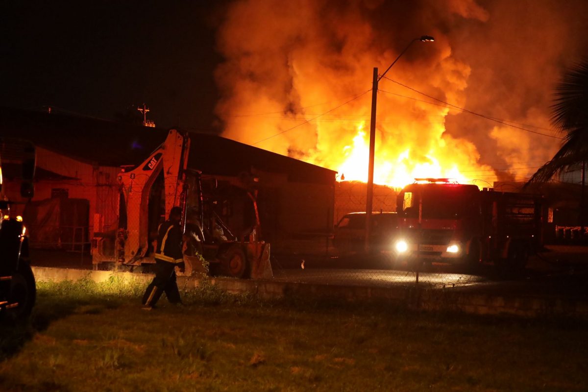 A fire officer looks on as fire engulfs the Gemini Inks building in Pt Lisas last night.