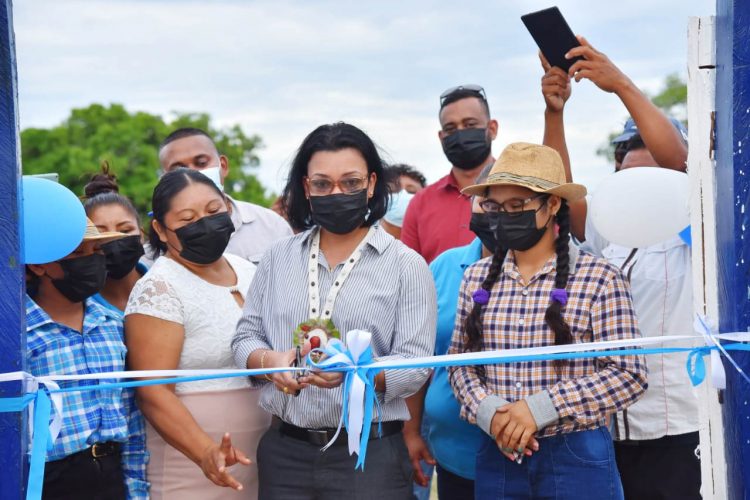 Minister Susan Rodrigues cuts the ribbon to commission the new Potarinau water system. (GWI photo)
