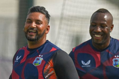 Ravi Rampaul (left) and Andre Russell share a light moment during recent training session.
