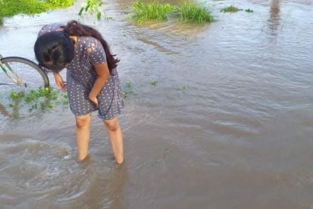 Residents walking in the flooded water 
