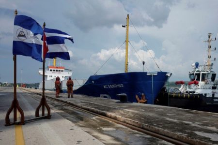 Nicaraguan and Cuban flags flutter as Nicaragua's merchant ship Augusto Cesar Sandino docks at the Mariel port with humanitarian shipment of food, Mariel, Cuba, August 6, 2021. REUTERS/Alexandre Meneghini