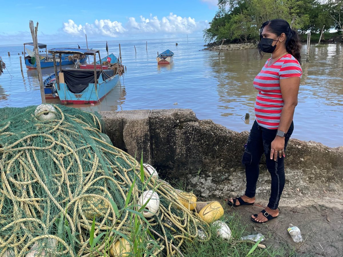 Going out of business: Soorsattie Chandrapaul looking at her fishing seine that was left at the koker