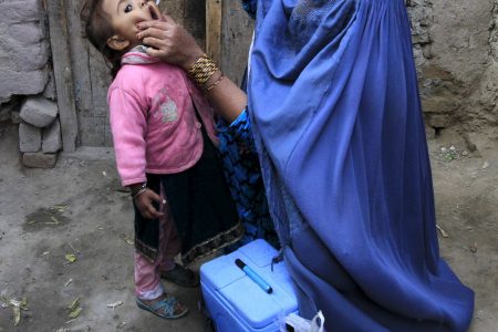 A child receives a polio vaccination during an anti-polio campaign on the outskirts of Jalalabad, Afghanistan, December 1, 2015. REUTERS/Parwiz