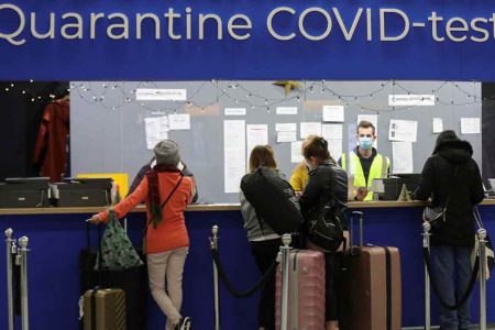 Passengers arrange COVID test appointments at Amsterdam’s Schiphol Airport on Nov. 27 after Dutch health authorities said that 61 people who arrived on flights from South Africa tested positive for the virus.   