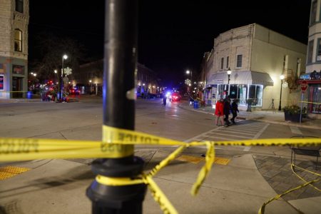 PHOTOGRAPHER: AP Photo/Jeffrey PhelpsPolice canvass the streets in downtown Waukesha, Wis., after a vehicle plowed into a Christmas parade hitting more than 20 people Sunday