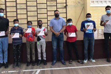 Berbice Cricket Board (BCB) Patron, Vickram Bharrat, surrounded by educational grant recipients