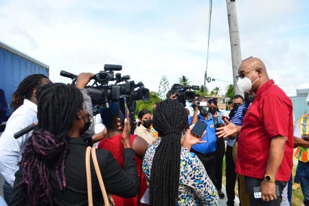 Minister of Public Works Juan Edghill (right) updating reporters on the project