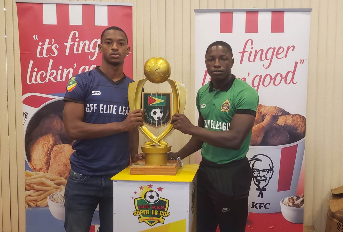 Western Tigers captain Curtez Kellman (left) and GDF skipper Sherwyn Caesar posing with the coveted trophy.