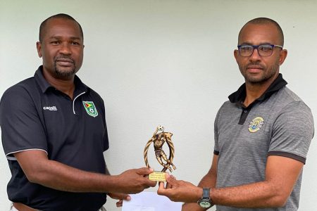 Director of the Eon DeVeira Goalkeeping Academy, Eon DeViera, (right) hands over the prizes to GFF President Wayne Forde