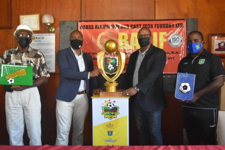 GFF President Wayne Forde (2nd from left) and BACIF Managing Director Peter Pompey ( 3rd from left) display the GFF-K&S Super 16 trophy and player award in the presence of company and federation representatives